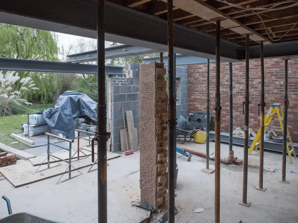 Property stripped to steel frame and exposed brickwork during heavy structural refurbishment