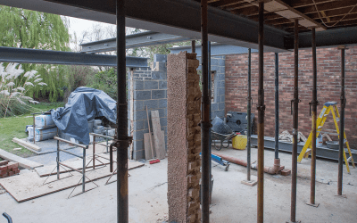 Property stripped to steel frame with acrow props and exposed brickwork during heavy structural refurbishment